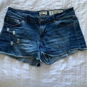 dark blue jeans with rips and frill on the bottom